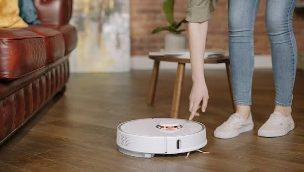 Robot vacuum cleaner working on a tiled floor in an Indian home