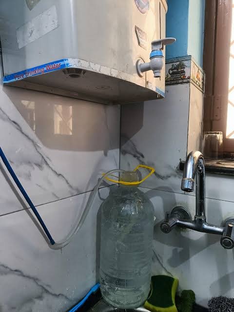 RO water purifier showing the reject water outlet pipe